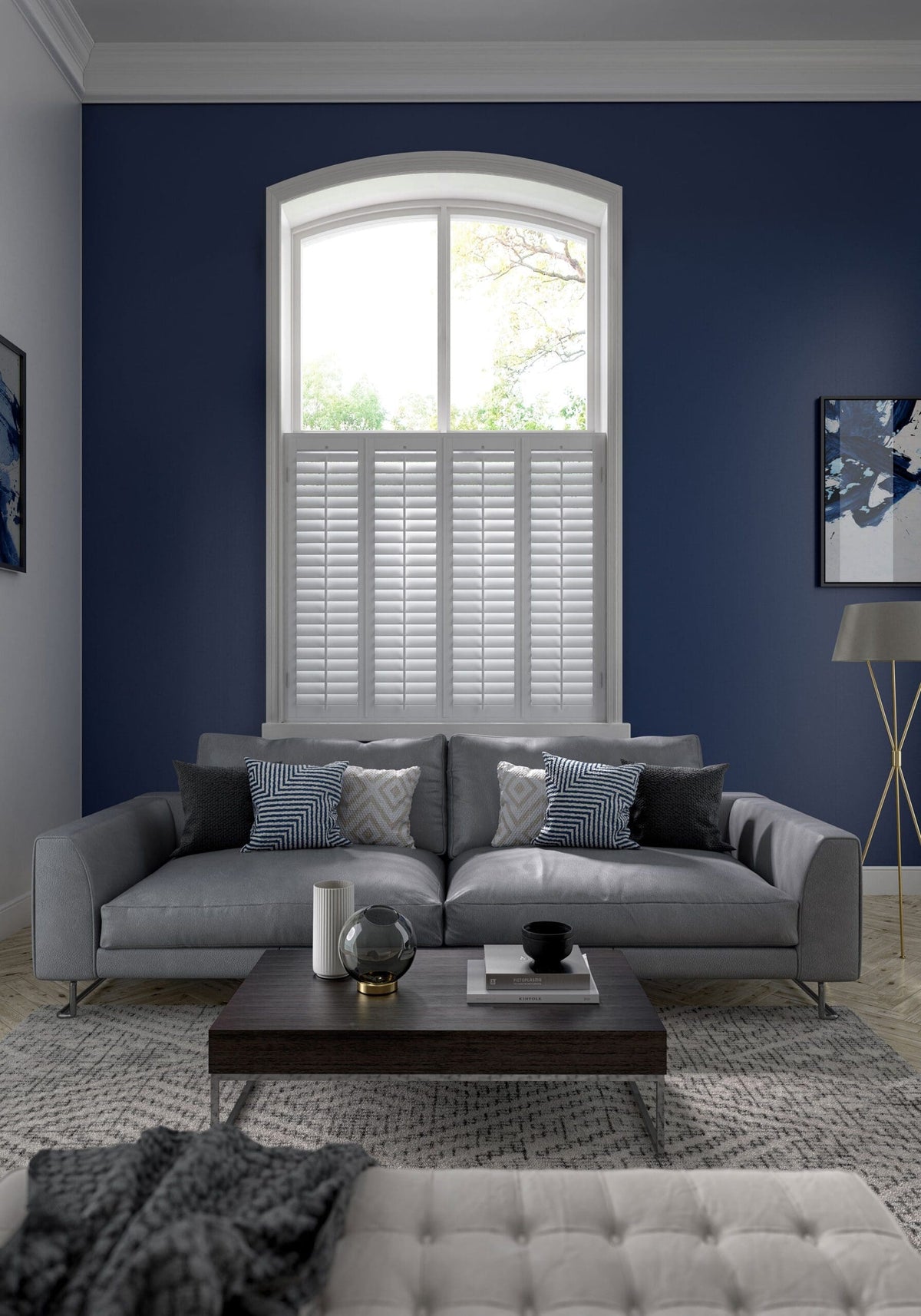White café style shutters on an arched window in a living room