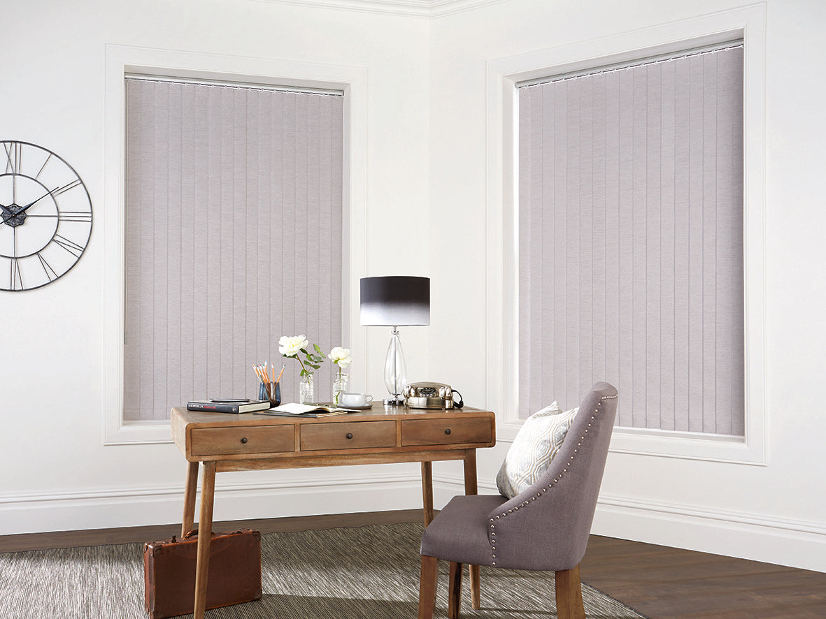Silver vertical blinds closed in a study