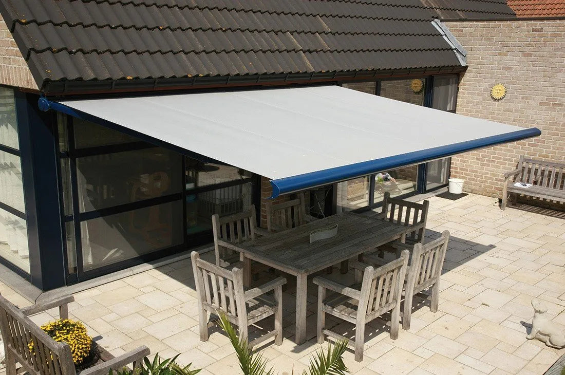 Awning over an outdoor dining table on a paved terrace